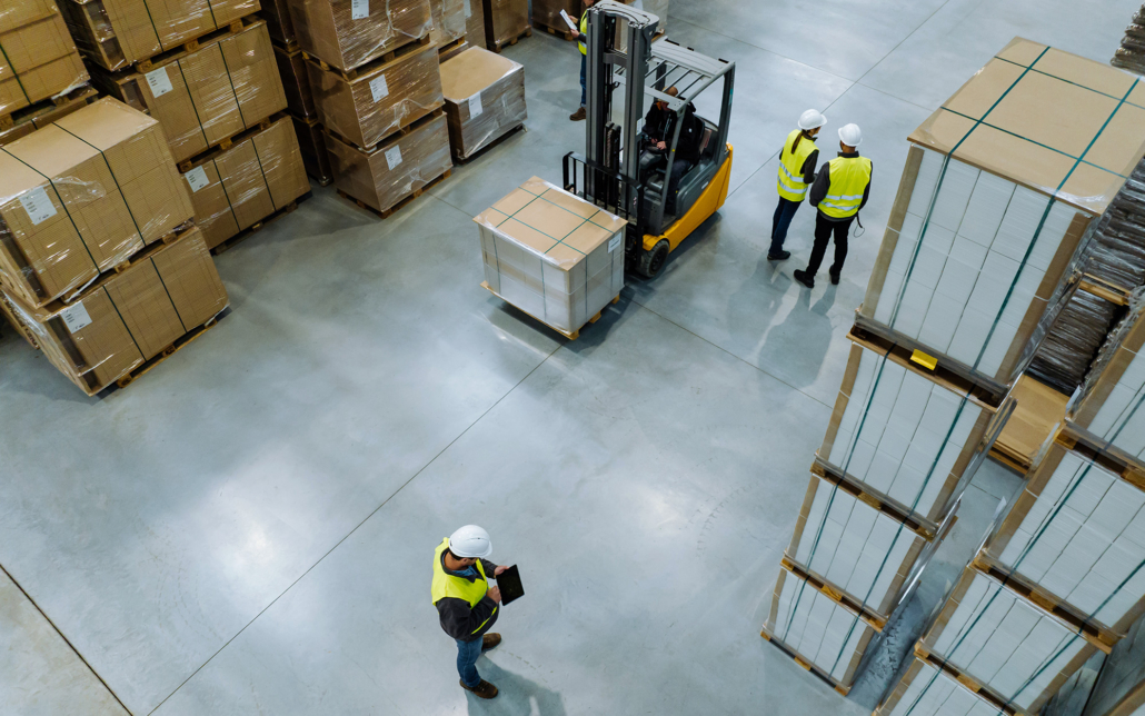 Workers Stack Boxes On Racks In Warehouse