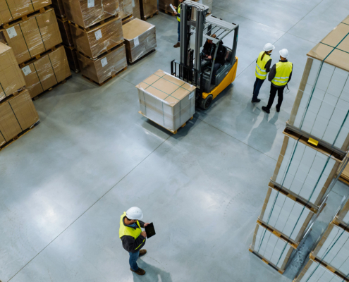 Workers Stack Boxes On Racks In Warehouse